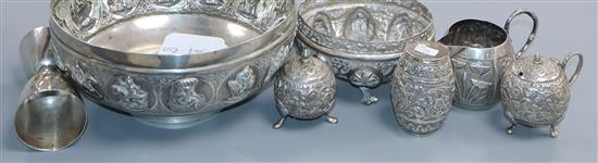 An Indian embossed white metal bowl, A. Bhica Jee & Co, Bombay, four Indian white metal condiments, a Chinese double measure etc